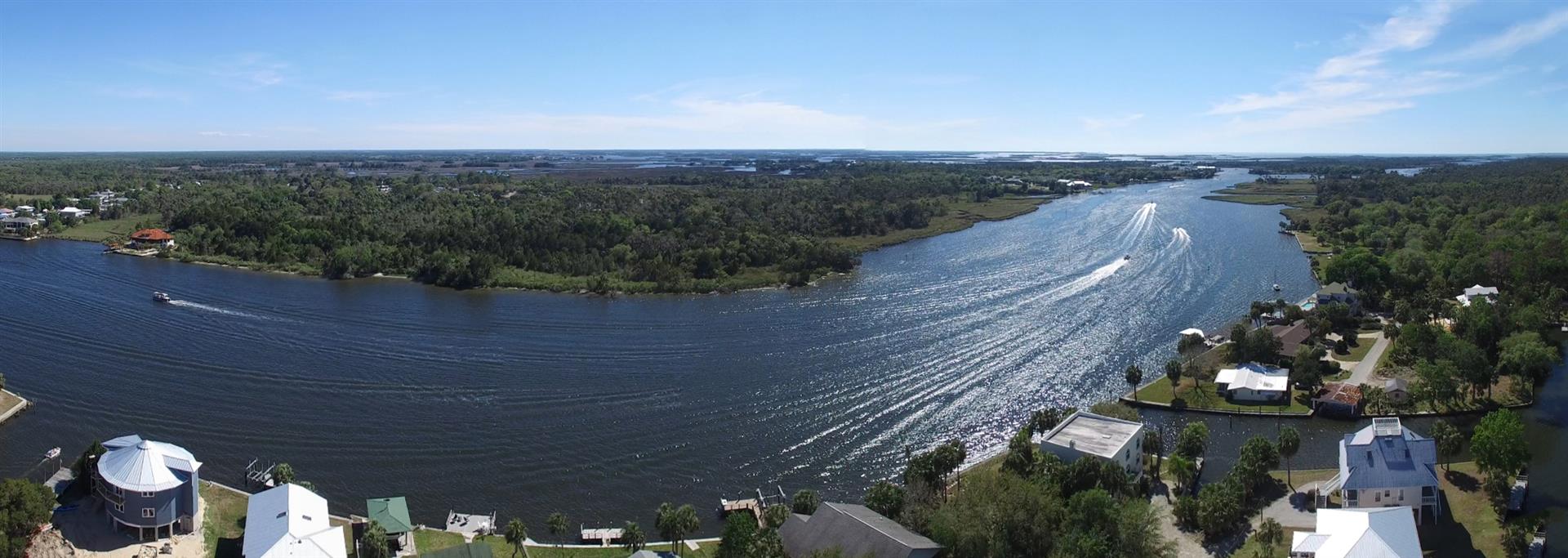 The Crystal River at Woodland Estates, aerial panorama shot with boats passing by